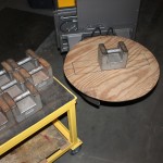 With the clamp in a partially closed position to support the platter, the platter should be placed onto the clamping jaws.  When stacking weights onto the platter, the first weight should be placed exactly in the center of the platter.