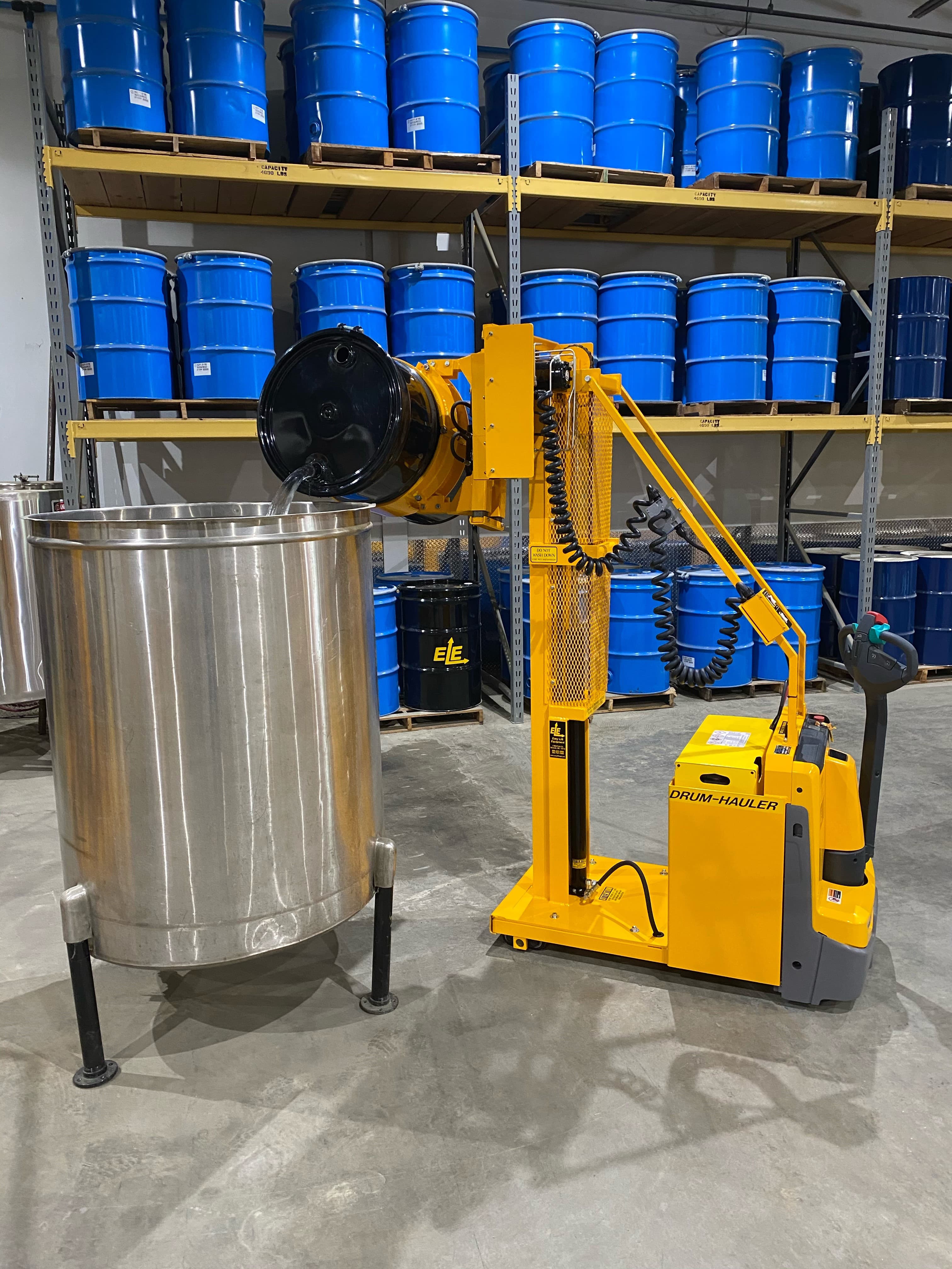 02-Drum-Hauler-Single-Stage-Mast-and-CR-Clamp-pouring-steel-drum-into-tank-min