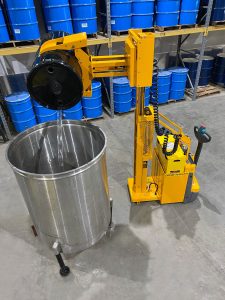03-Drum-Hauler-with-1324-8-Ext.-Reach-Clamp-dumping-drum-into-tank-min