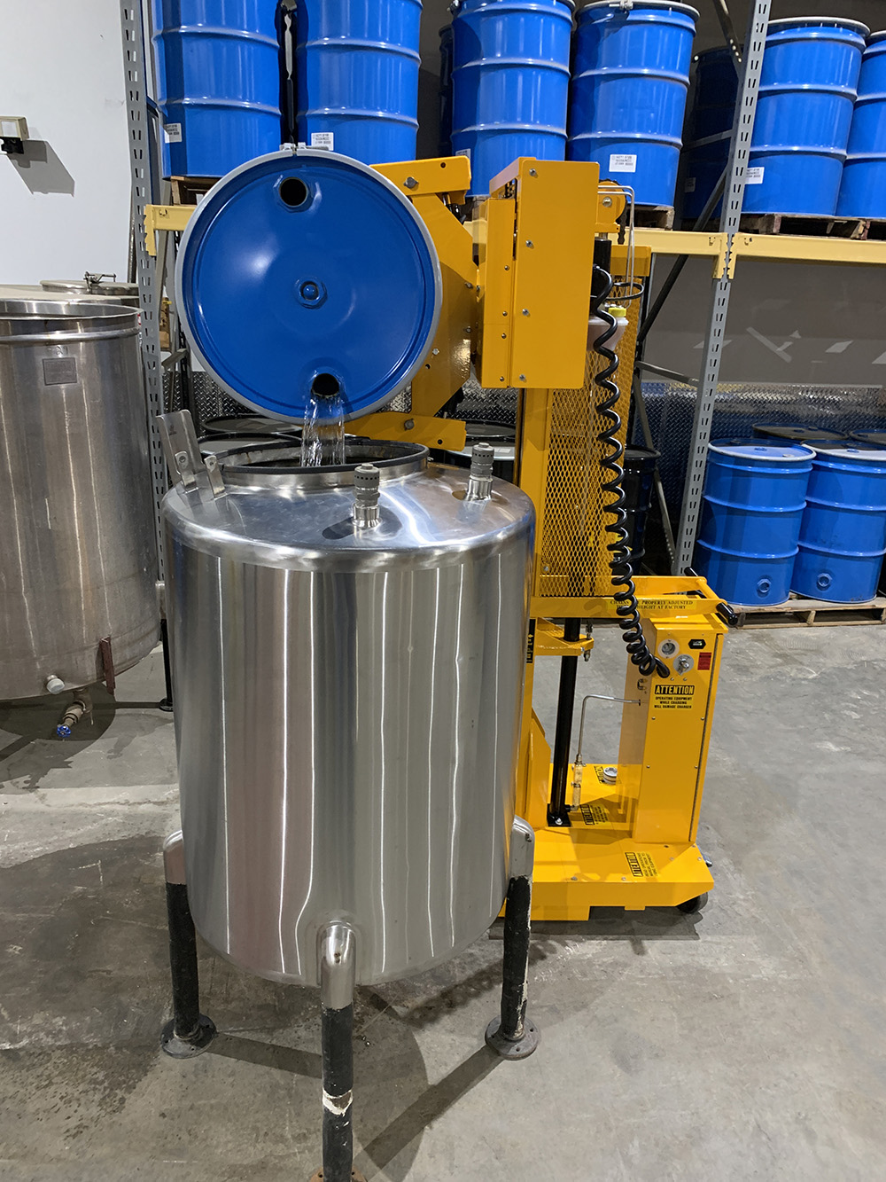 03-DC-Powered-ELDR-dumping-steel-drum-into-tank